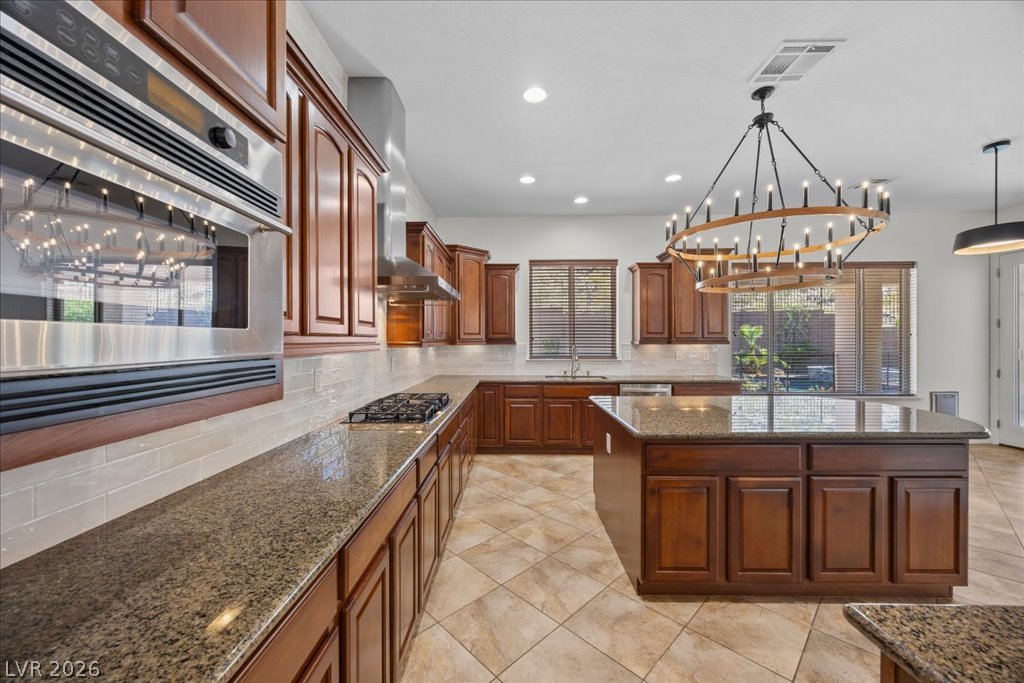 2125 De Rouge Avenue Henderson, NV 89044 - Photo 44 of 96 A well-lit kitchen with rich wood cabinetry and ample counter space.
