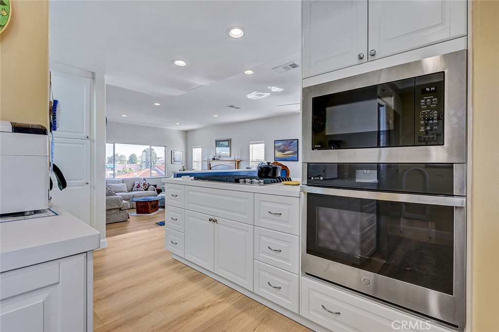 318 Penn Street, Unit 2 El Segundo, CA 90245 - Photo 7 of 28 a kitchen with stainless steel appliances kitchen island granite countertop a stove microwave and cabinets