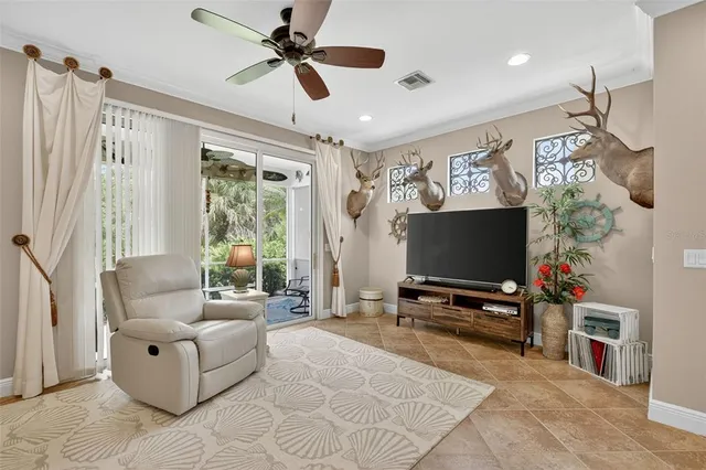 a spacious bedroom with a large bed and a chandelier