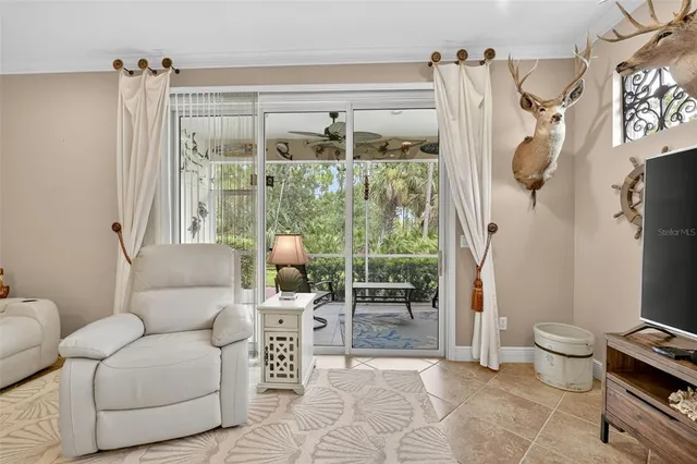 a bedroom with a bed and a flat tv screen on dresser