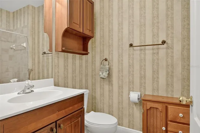 a front view of a house with a yard and potted plants