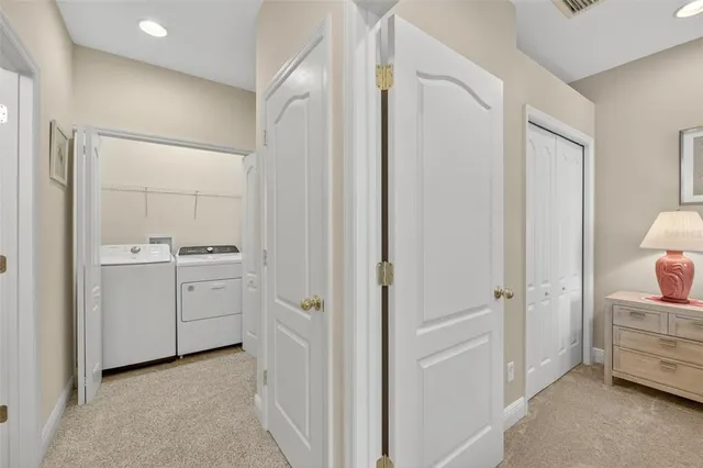 a front view of a house with a yard and potted plants