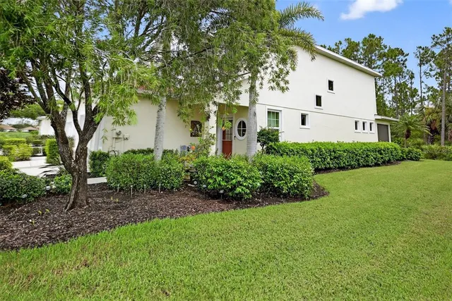 a view of a house with lounge chairs in patio