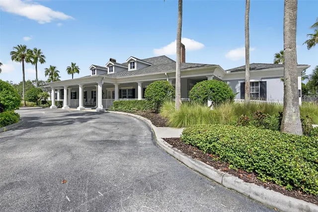 a dining room with furniture a floor to ceiling window and wooden floor