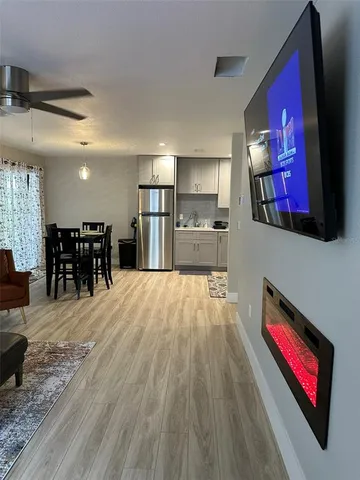 a living room with a fireplace and a flat screen tv