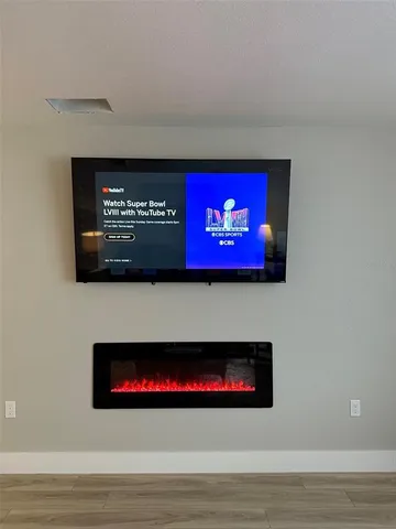 a bedroom with a bed and a lamp on dresser