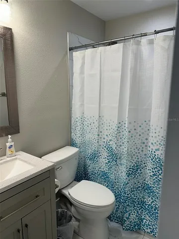 a white toilet sitting next to a bathroom sink