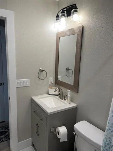 a bathroom with a sink vanity and a mirror