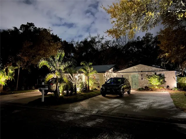 a view of a back yard of the house and cars parked