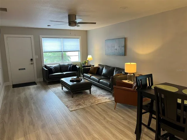 a living room with furniture a rug and a window