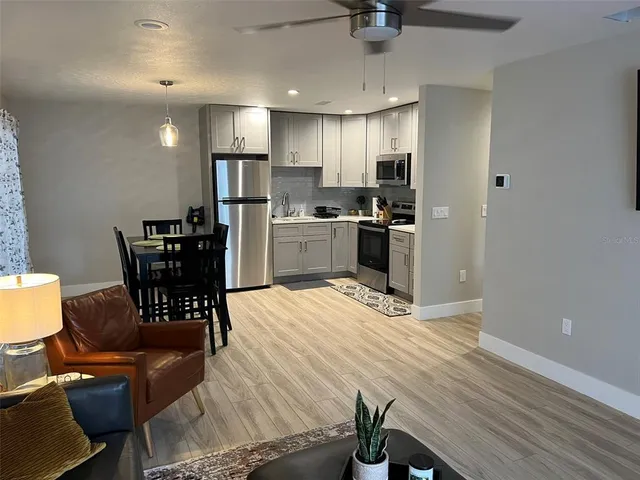 a kitchen that has a table and chairs in it