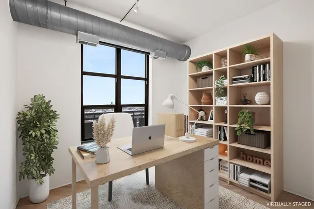 a workspace with furniture and a potted plant