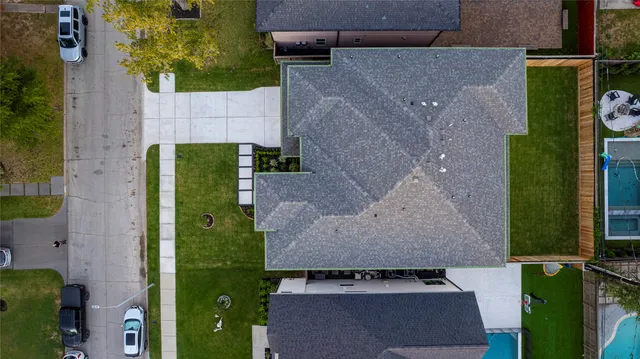 an aerial view of a house with a yard