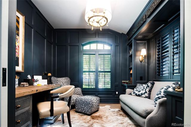 a living room with furniture and a large mirror