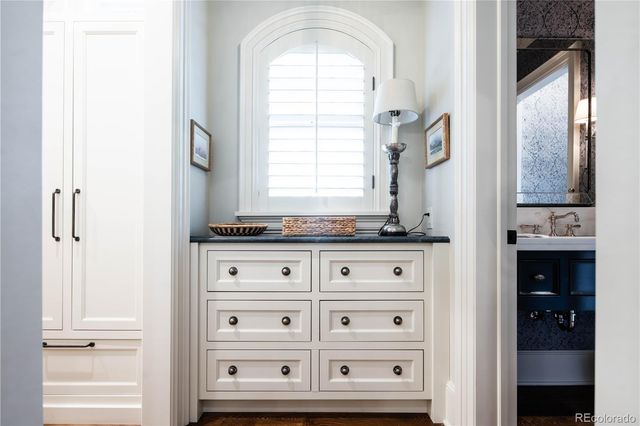 a view of granite countertop white cabinets and window