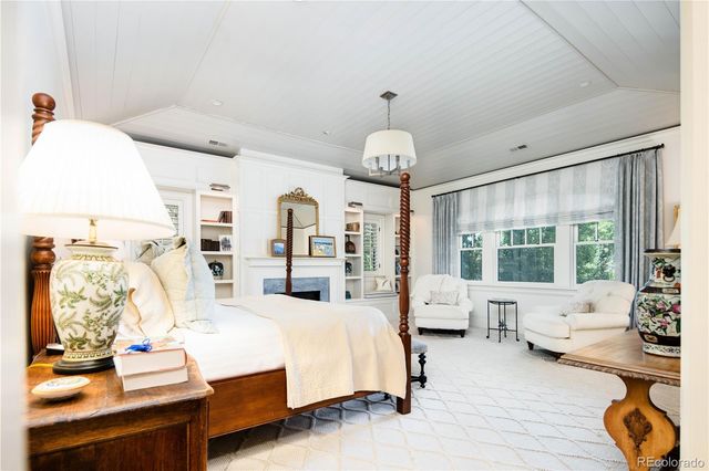 a spacious bedroom with bed and a large window