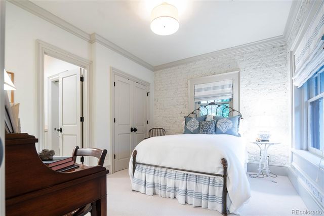 a living room with a bed furniture and a window