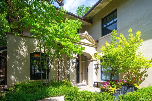 a front view of a house with plants