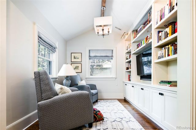 a living room with furniture fireplace and baby crib
