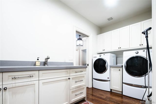 a kitchen with a stove a sink and cabinets