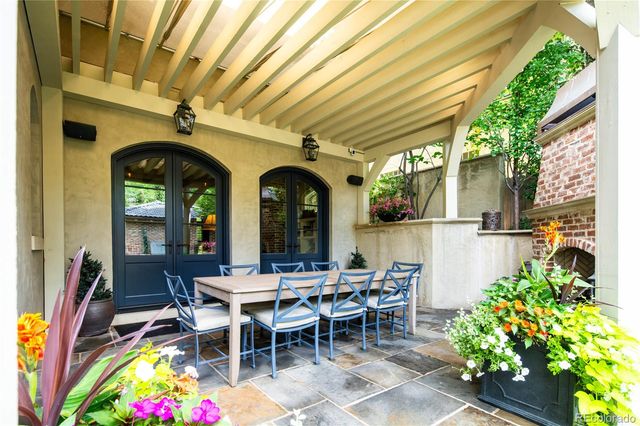 a view of a patio with a table and chairs and potted plants