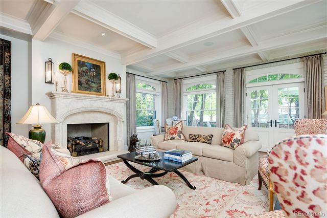 a living room with furniture fireplace and window
