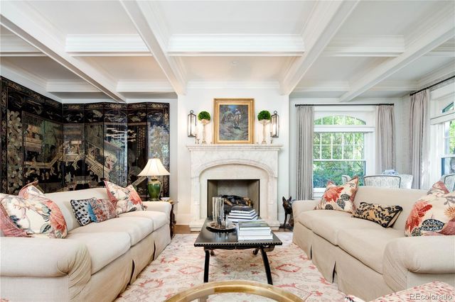 a living room with furniture fireplace and window