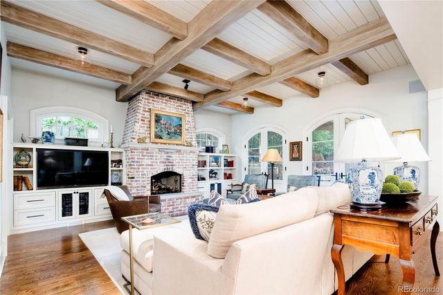 a living room with furniture a fireplace and a flat screen tv