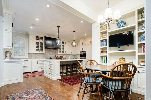 a view of a dining room with furniture and a flat screen tv