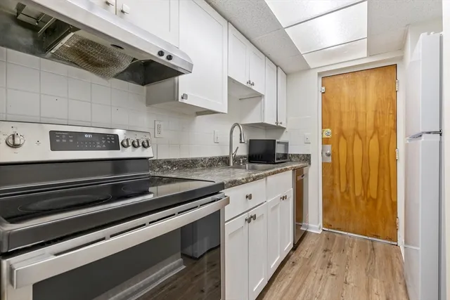 a kitchen with stainless steel appliances a sink a stove and a refrigerator