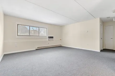 an empty room with a empty space and windows