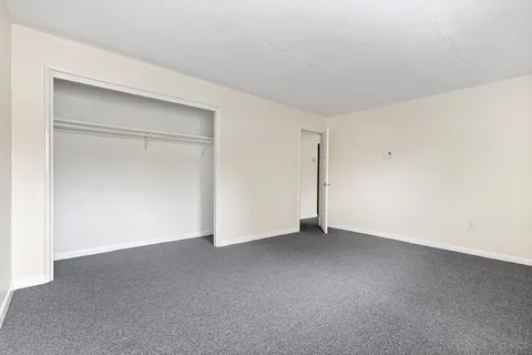 a white toilet sitting next to a bath tub