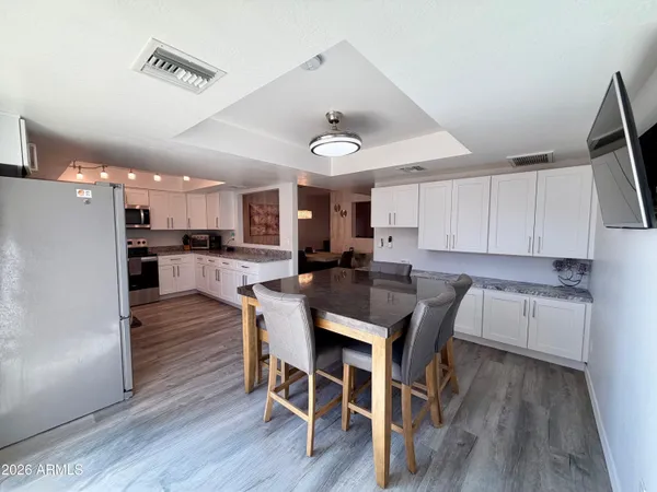 a view of a dining room with furniture and wooden floor