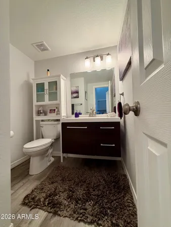 a kitchen with stainless steel appliances kitchen island granite countertop a table chairs and a refrigerator