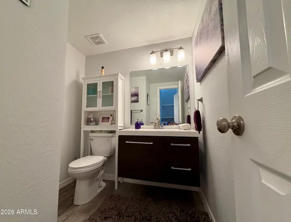 a kitchen with a table chairs microwave and cabinets