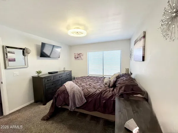a spacious bathroom with a toilet a sink and mirror