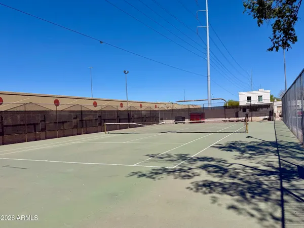 a view of a white house with a big yard and large tree