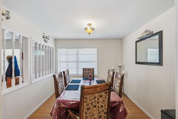 a bedroom with a chair and a workspace