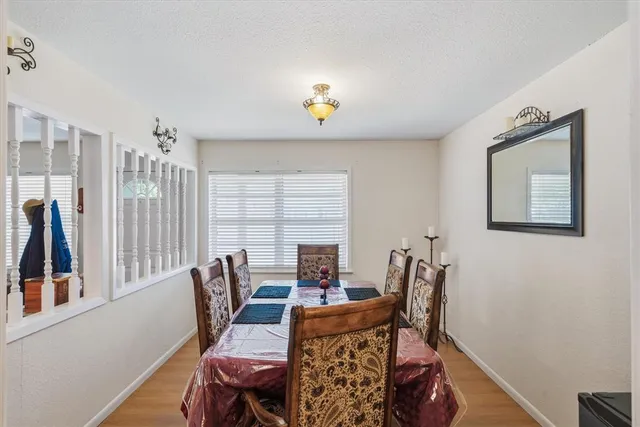 a bedroom with a chair and a workspace