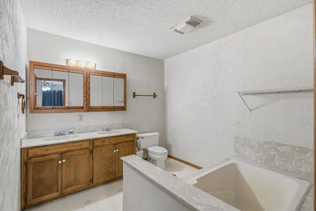 a view of a house with a yard covered in snow