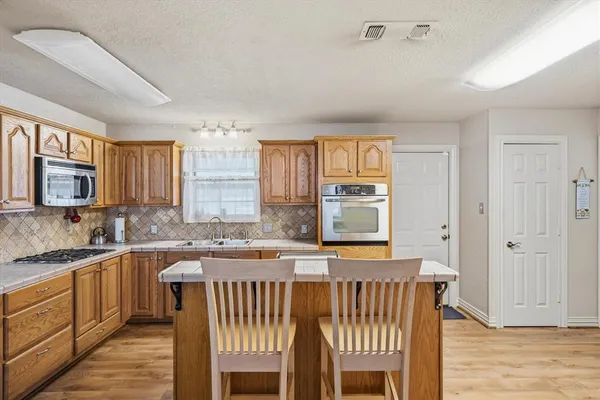 a kitchen with stainless steel appliances granite countertop a stove and a refrigerator