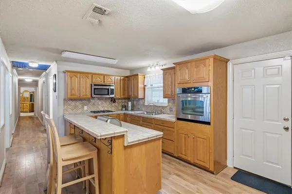 a kitchen that has a cabinets counter space and stainless steel appliances