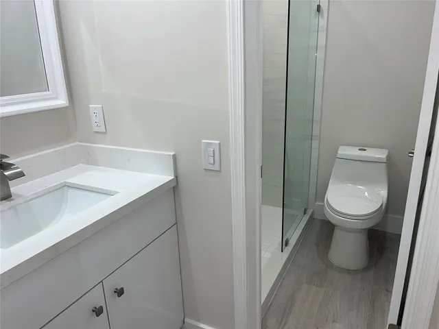 a white toilet sitting next to a bathroom sink