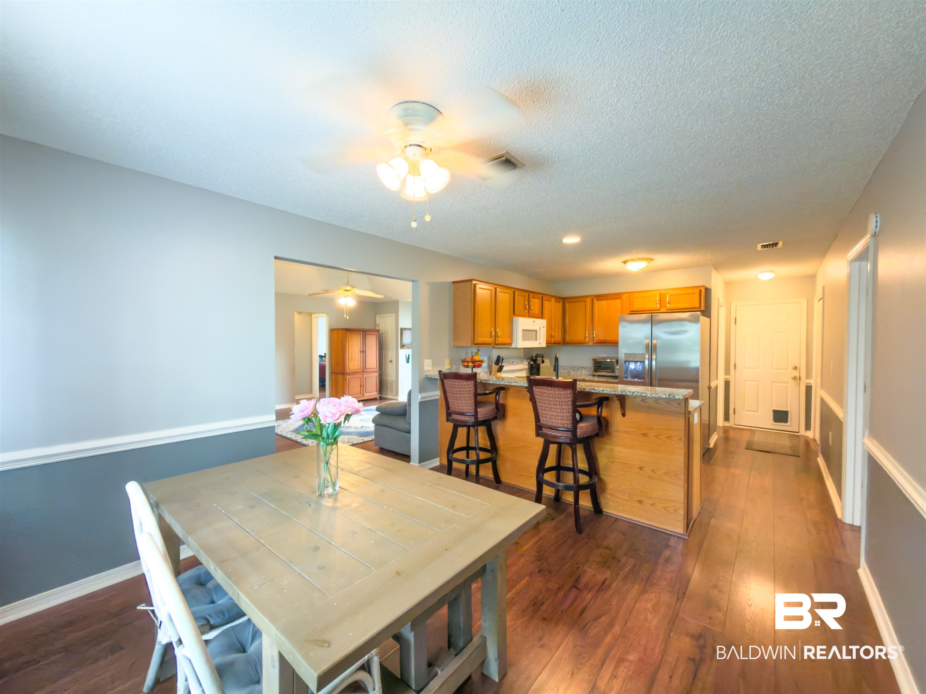 129 Pennbrooke Loop Foley, AL 36535 - Photo 19 of 44 Dining area featuring dark wood-style floors and ceiling fan