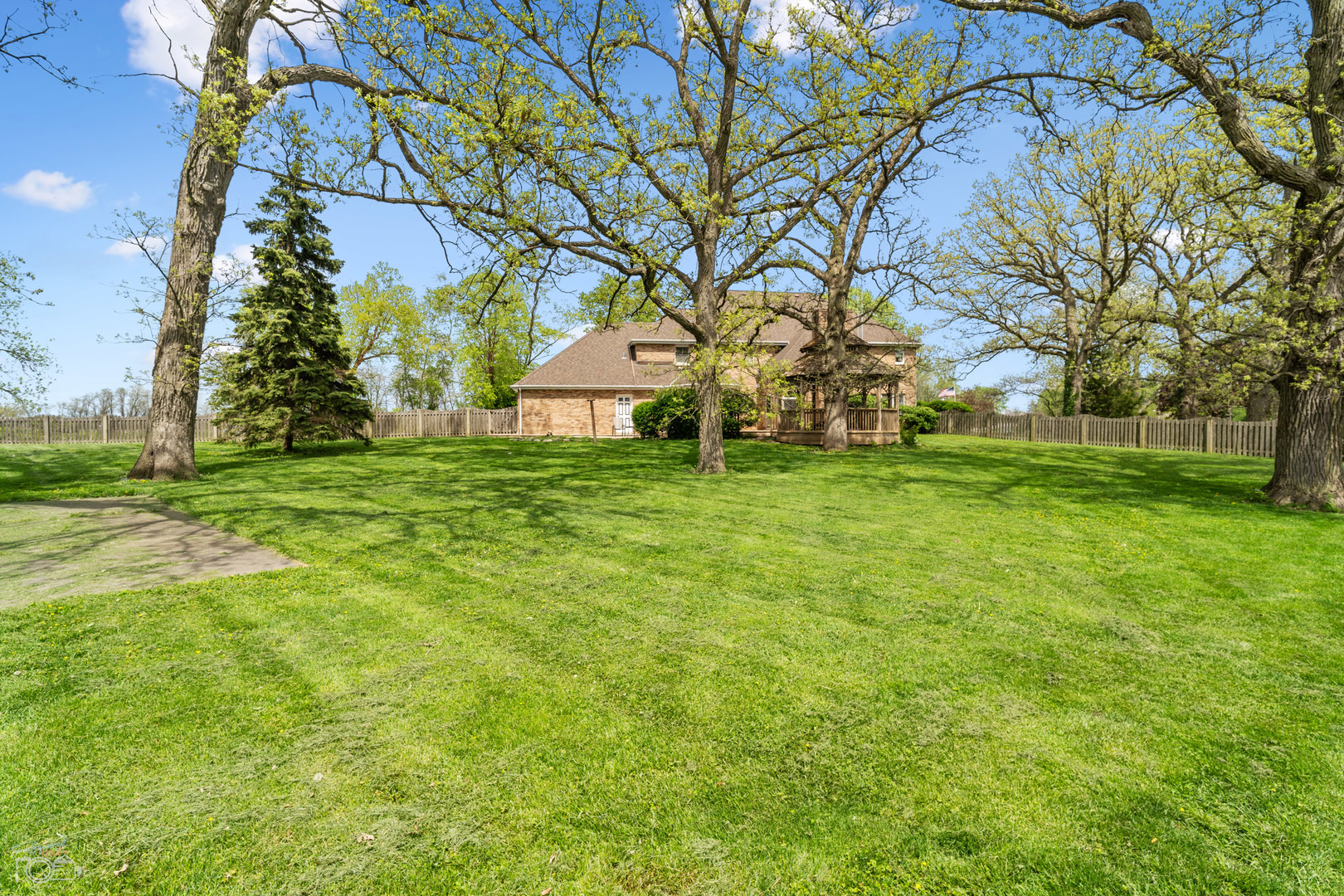 16015 West Baker Road Manhattan, IL 60442 - Photo 12 of 66 a backyard of a house with lots of green space and fountain