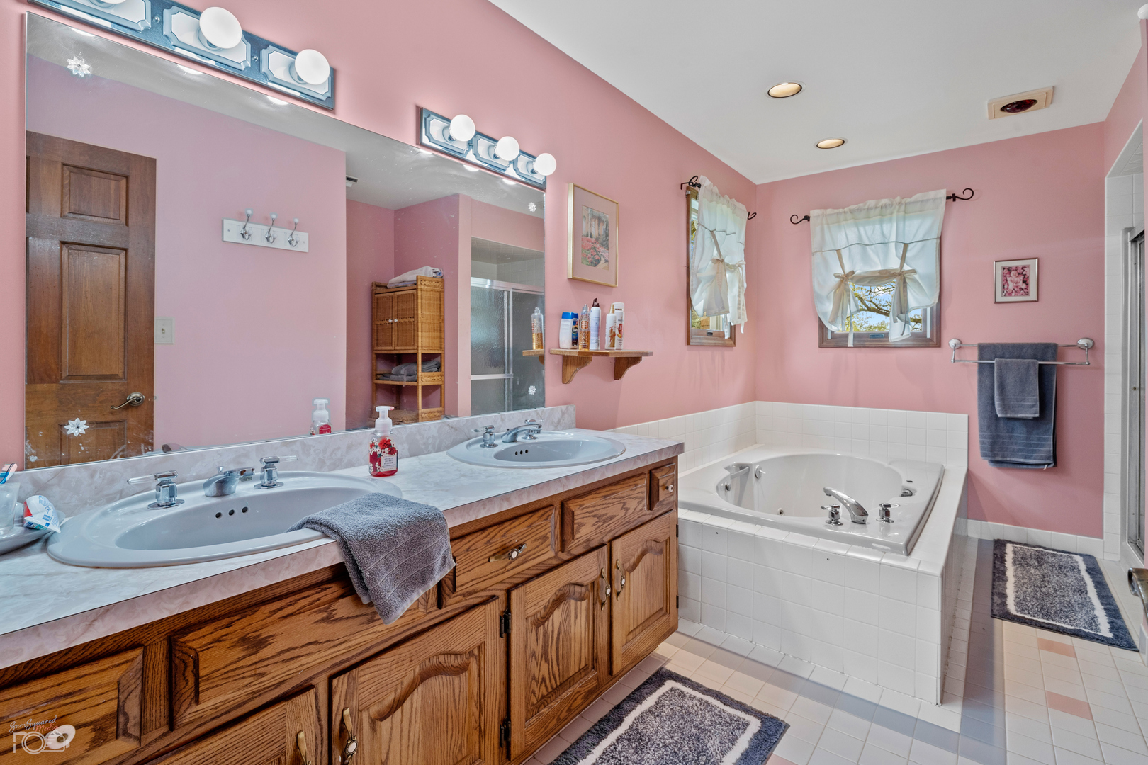 16015 West Baker Road Manhattan, IL 60442 - Photo 46 of 66 a bathroom with a granite countertop sink a large mirror a bathtub and next to a window