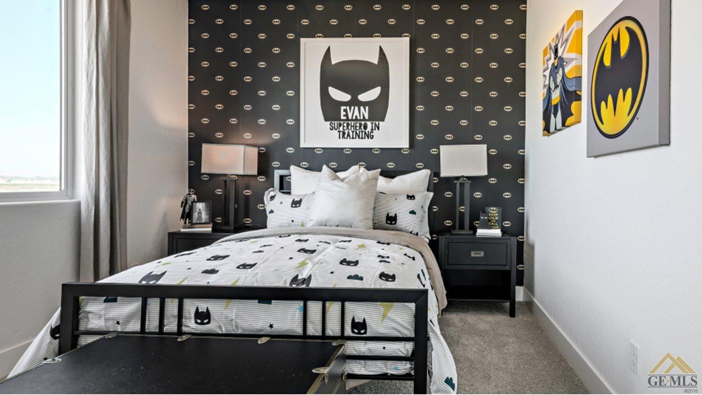 Undisclosed Address Bakersfield, CA 93313 - Photo 11 of 17 a bedroom with a bed and dresser with mirror