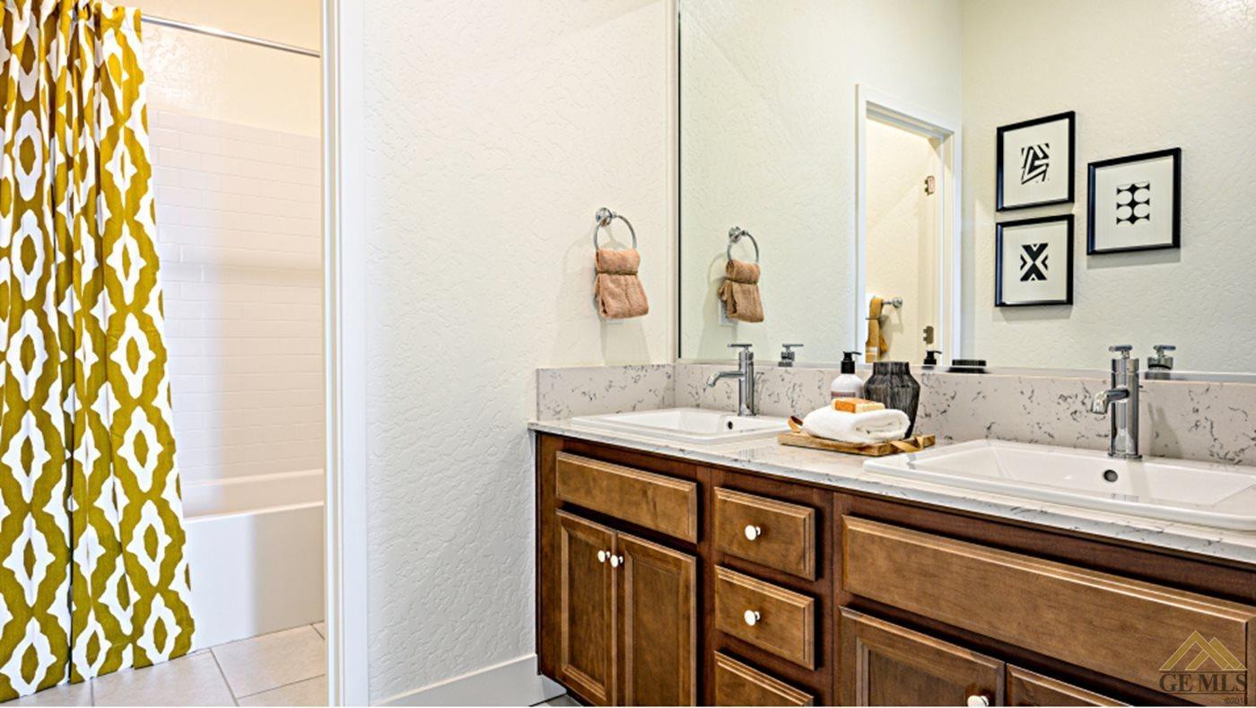 Undisclosed Address Bakersfield, CA 93313 - Photo 14 of 17 a bathroom with a sink and a mirror
