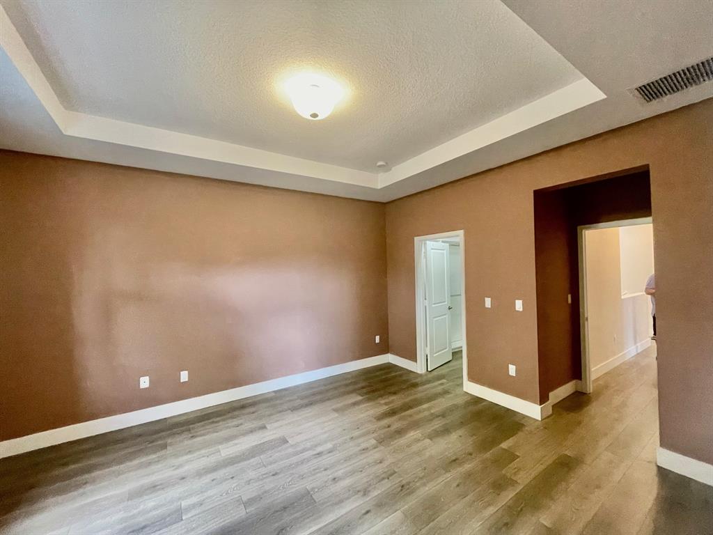 4803 Northwest 48th Terrace Tamarac, FL 33319 - Photo 11 of 28 an empty room with wooden floor and closet