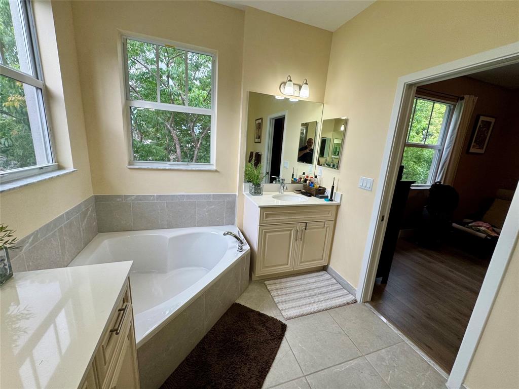 4803 Northwest 48th Terrace Tamarac, FL 33319 - Photo 14 of 28 a bathroom with a bathtub a sink and a window